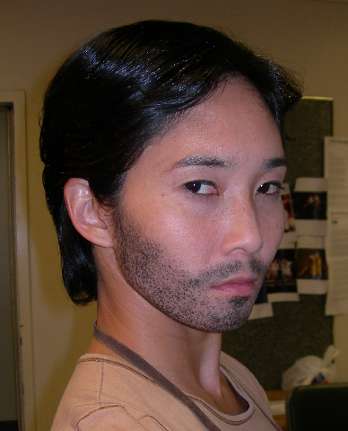 female dancer in male theatrical makeup